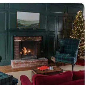 Green-paneled sitting room with fireplace