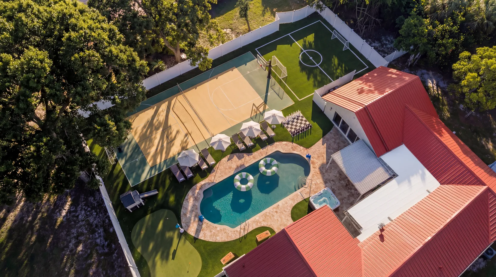 Aerial of the resort-style backyard, pool and courts