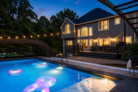 Heated pool under the enclosure at night