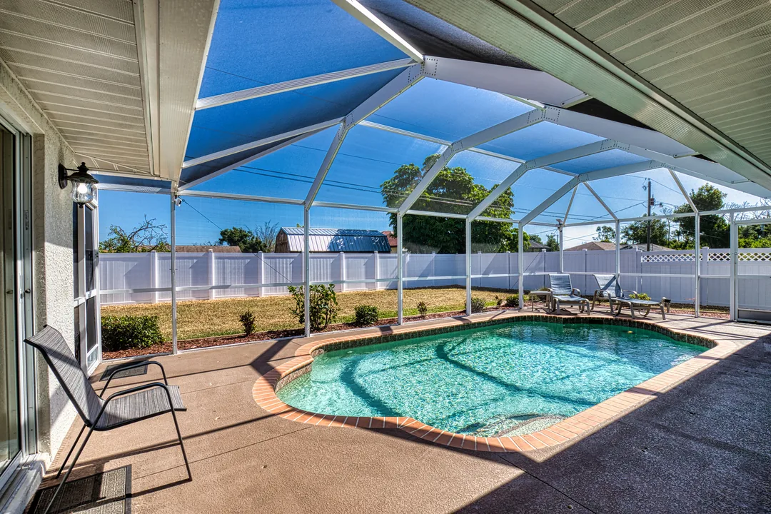 Screened lanai pool, browning lawn beyond