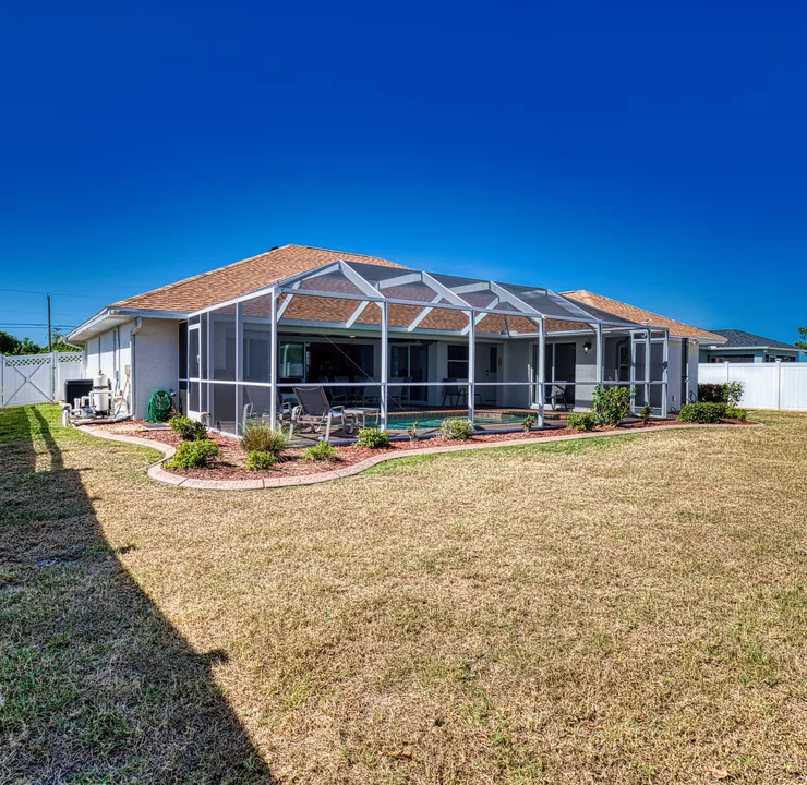Backyard with screened pool enclosure