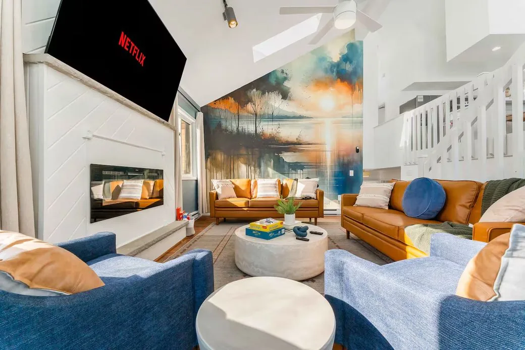 Living room with mural, fireplace and TV