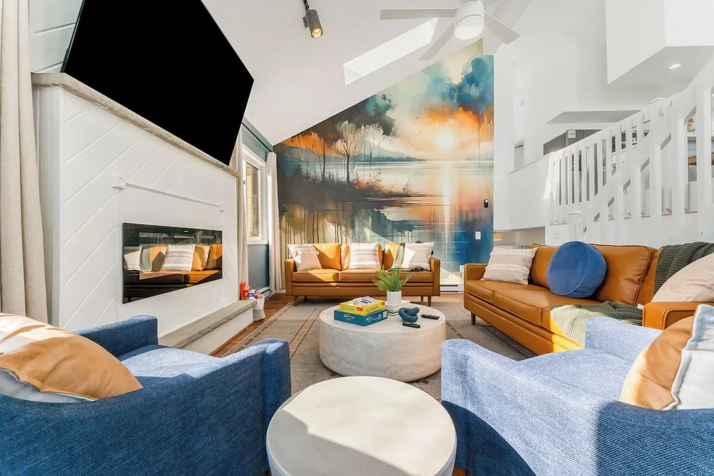 Living room with mural and fireplace